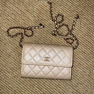 Champagne colored Chanel gold wallet on a chain with pearl strap